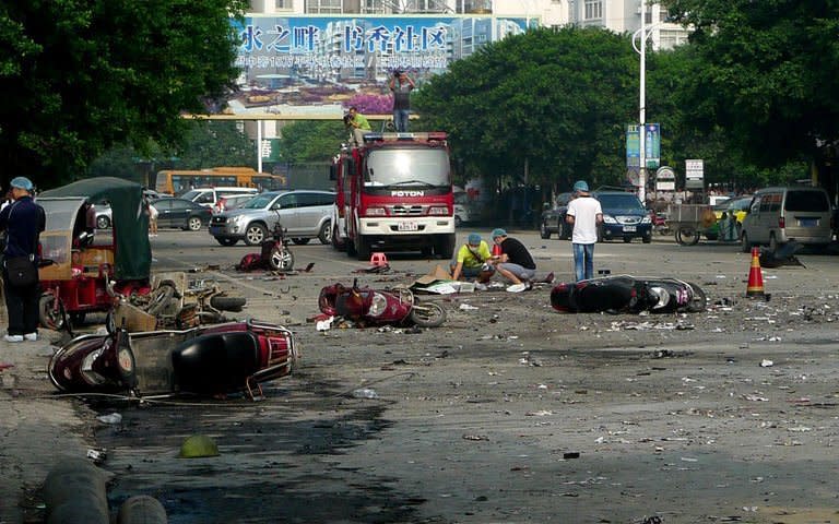 Damaged motorbikes and debris lie on the ground after an explosion outside a primary school in Guilin, southwest China's Guangxi province on September 9, 2013, which killed two people and injured at least 44 others, 26 of them schoolchildren, state-run media and a local official said