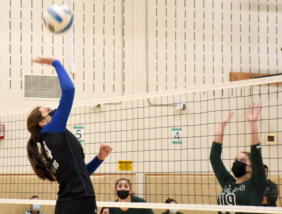 Maggie Worobey (left) swats the ball over the net for Owen D. Young/Richfield Springs toward Herkimer Magician Izabella Vredenburg (19) during the fourth game of the Wildcats come-from-behind 3-2 victory Monday.