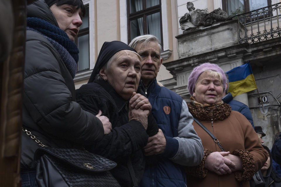 The mother of 40-year-old Senior lieutenant, Oliynyk Dmytro, mourns his death during his funeral ceremony, after being killed in action, outside the Holy Apostles Peter and Paul Church, in Lviv, western Ukraine, Saturday, April 2, 2022. (AP Photo/Nariman El-Mofty)
