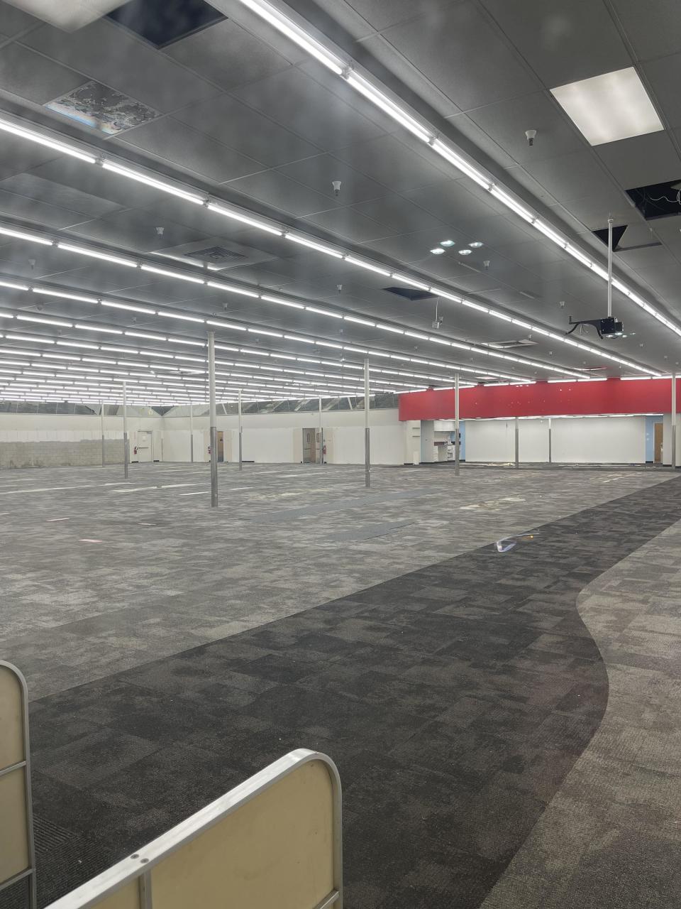 An empty, bare open space without aisles, shelves, checkout, or items for purchase