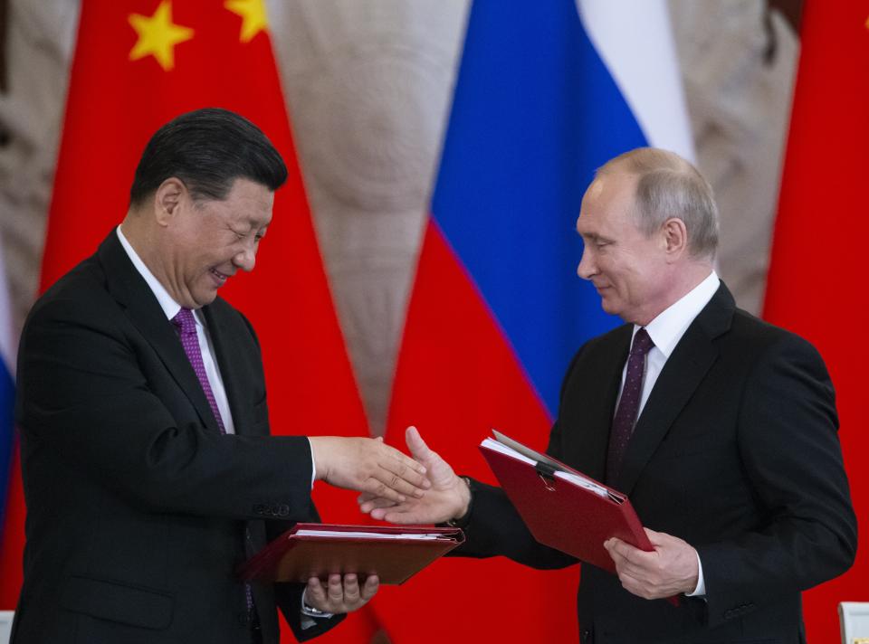 Russian President Vladimir Putin, right, and Chinese President Xi Jinping exchange documents during a signing ceremony following their talks in the Kremlin in Moscow, Russia, Wednesday, June 5, 2019. Chinese President Xi Jinping is on visit to Russia this week and is expected to attend Russia's main economic conference in St. Petersburg. (AP Photo/Alexander Zemlianichenko, Pool)