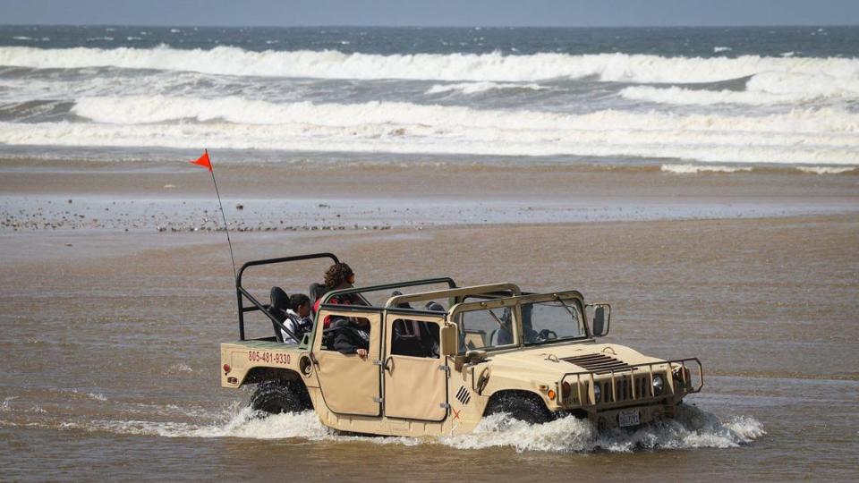 A hummer crosses Arroyo Grande Creek at the Oceano Dunes on April 12, 2023. High flow from Arroyo Grande Creek and high tides sweeping the beach have limited access to the Oceano Dunes to day use from 7 a.m. to 2 p.m. David Middlecamp/dmiddlecamp@thetribunenews.com
