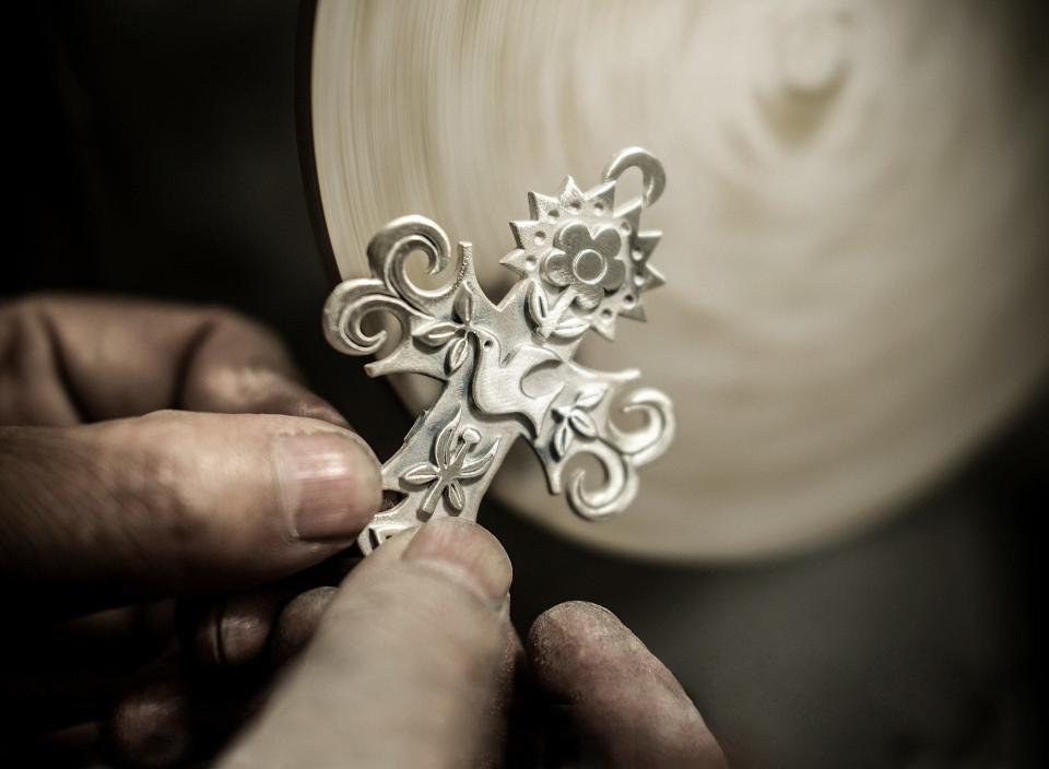 A James Avery craftsman works on a charm for the jewelry store.