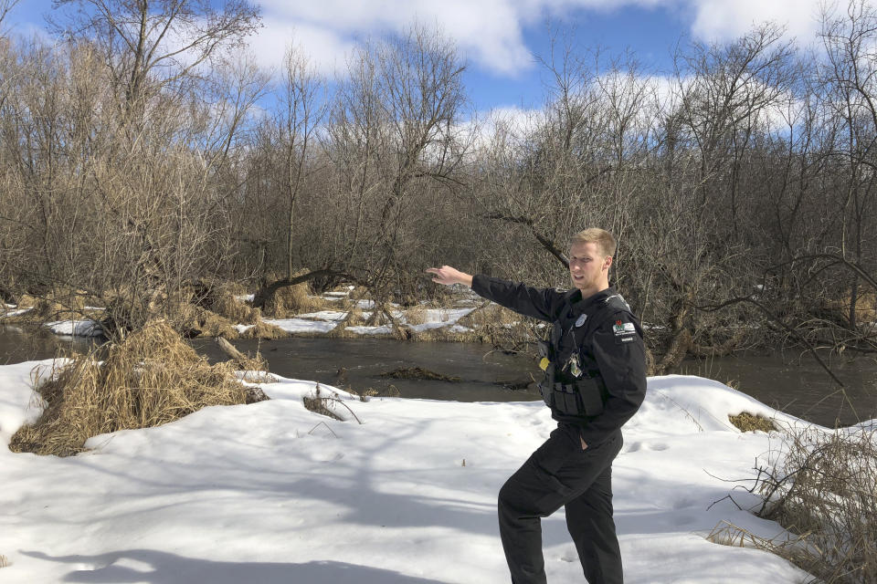 In this March 5, 2020 photo, Wisconsin Department of Natural Resources Warden Austin Schumacher stands on the edge of a marsh in Edgerton, Wis., where a 13-year-old boy disappeared after running away from school in November 2019. Schumacher used old-school tracking skills to find and rescue the child moments before a snowstorm struck. This month, Schumacher received the DNR’s Lifesaving Award. (AP Photo/Todd Richmond)
