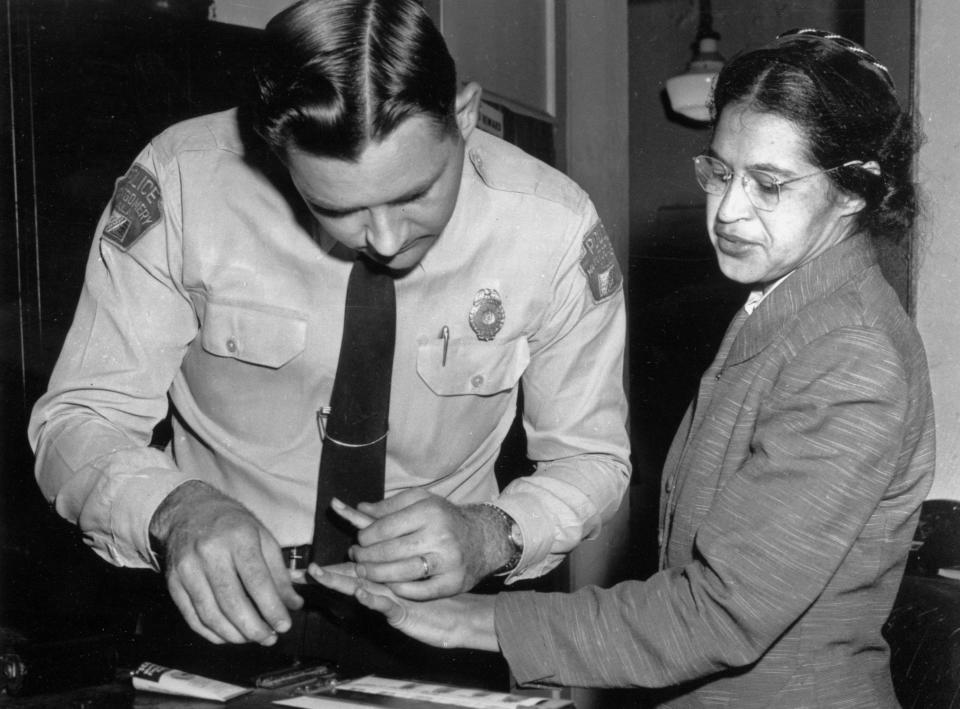 FILE - In this Feb. 22, 1956, file photo, Rosa Parks is fingerprinted by police Lt. D.H. Lackey in Montgomery, Ala., two months after refusing to give up her seat on a bus for a white passenger on Dec. 1, 1955. She was arrested with several others who violated segregation laws. (AP Photo/Gene Herrick, File)