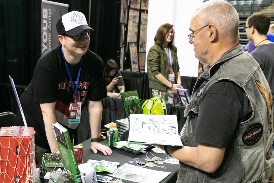 Greg Smith talks to a fan of "Junior Braves of the Apocalypse" at a convention.