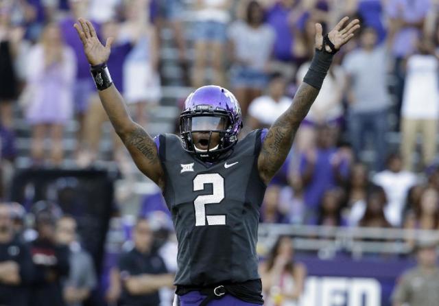 TCU quarterback Trevone Boykin (2) celebrates a score against Texas Tech in the second half of an NCAA college football game, Saturday, Oct. 25, 2014, in Fort Worth, Texas. Boykin threw a school-record seven touchdown passes and No.10 TCU showcased a new fast-paced offense by scoring the most points in its history in an 82-27 rout of Texas Tech on Saturday. (AP Photo/Tony Gutierrez)