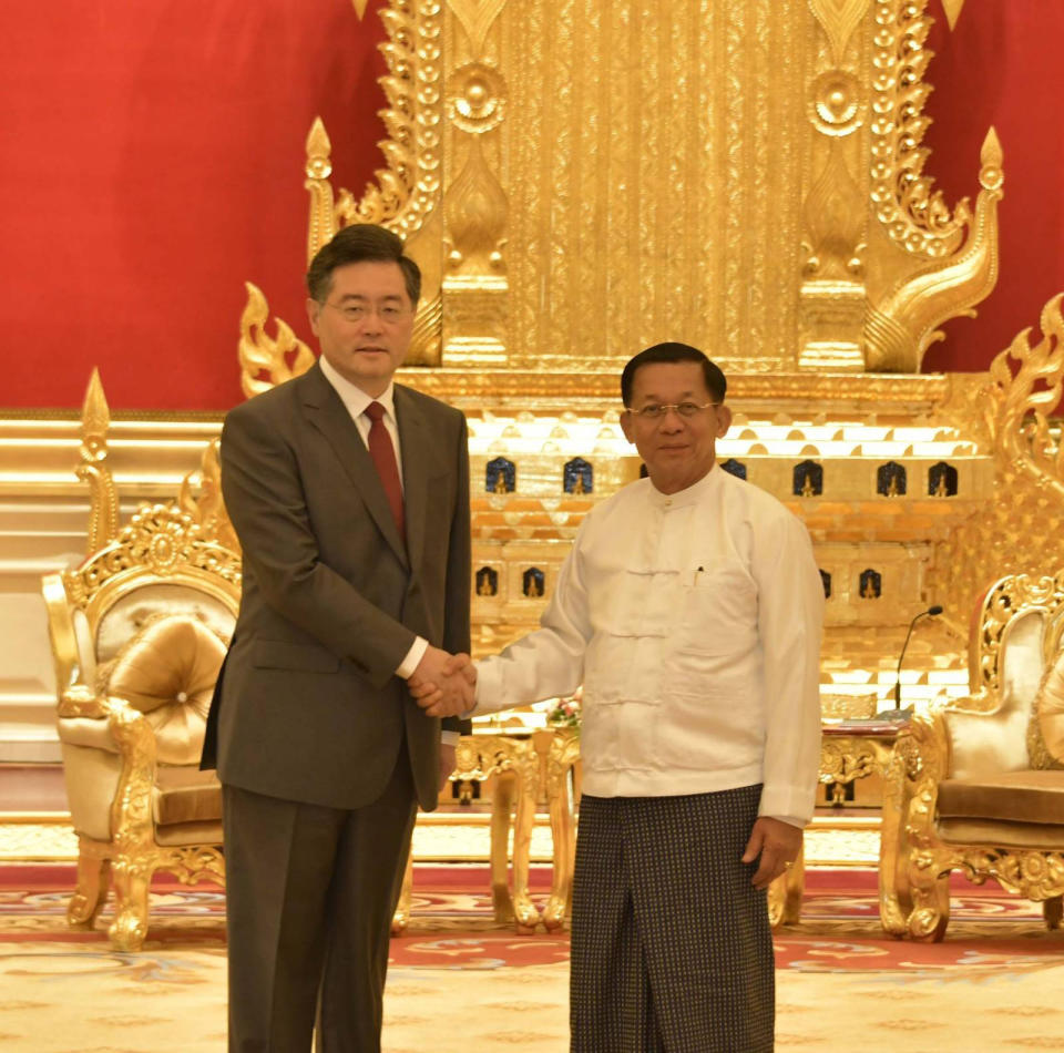 In this photo provided by the Myanmar Military True News Information Team, Senior Gen. Min Aung Hlaing, right, head of the military council, shakes hands with Chinese Foreign Minister Qin Gang, left, during their meeting Tuesday, May 2, 2023, in Naypyitaw, Myanmar.The head of Myanmar's military-controlled government, Senior Gen. Min Aung Hlaing, met Tuesday with the visiting foreign minister of China, one of the army regime's closest allies offering key support to its continued rule since seizing power two years ago. (Military True News Information Team via AP)