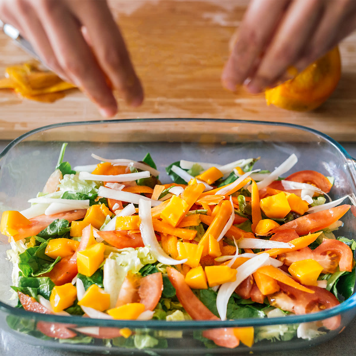 woman preparing tray of roasted vegetables