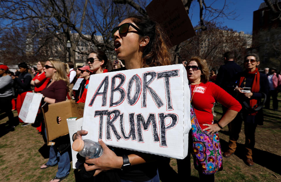 A protester holds a sign aloft as she and hundreds of other activists demonstrate outside the White House as part of “A Day Without a Woman” strike on International Women’s Day in Washington, U.S., March 8, 2017. (Photo: Kevin Lamarque/Reuters)