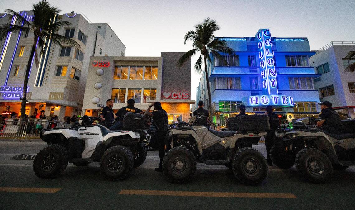 Police stand relaxed on Ocean Drive during spring break on Sunday, March 17, 2024, in South Beach.