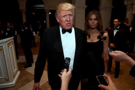 U.S. President-elect Donald Trump talks to reporters as he and his wife Melania Trump arrive for a New Year's Eve celebration with members and guests at the Mar-a-lago Club in Palm Beach, Florida, U.S. December 31, 2016. REUTERS/Jonathan Ernst