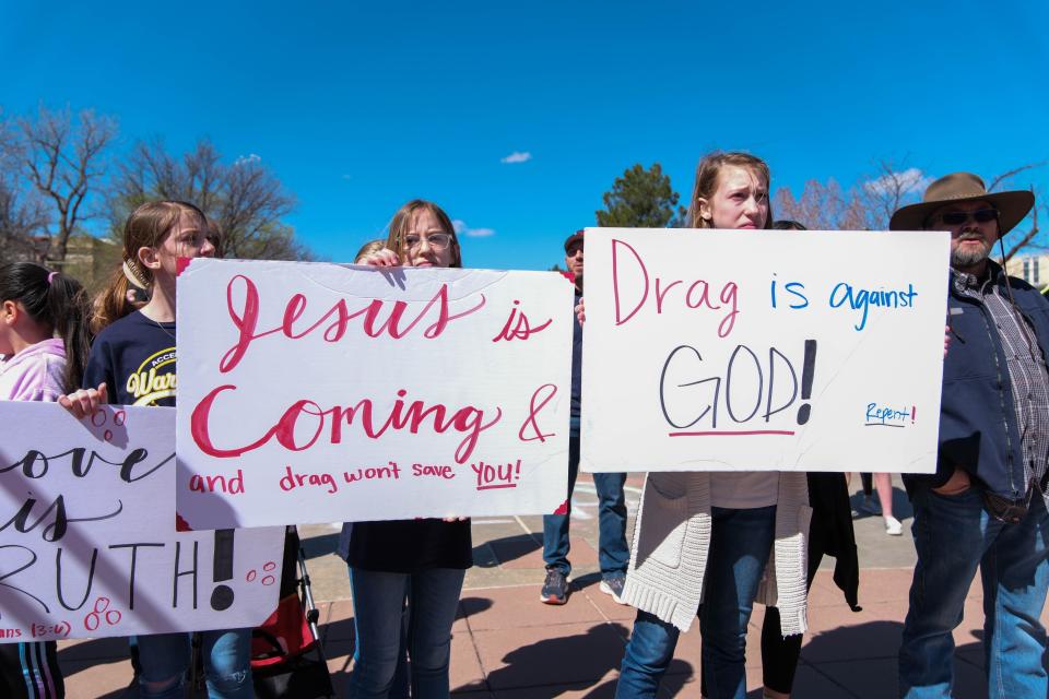 Child counter-protesters hold signs at West Texas A&M University to support the university president's decision to cancel a drag show at the university.