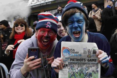 Fans celebrate during the New England Patriots Super Bowl XLIX victory parade in Boston, Massachusetts February 4, 2015. REUTERS/Katherine Taylor