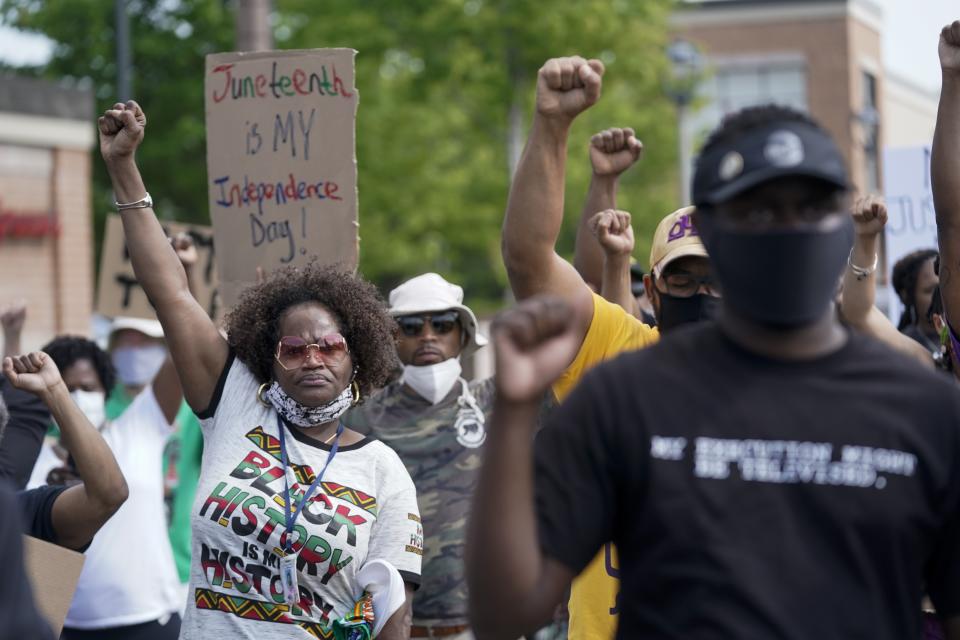 People march during a Juneteenth event Friday, June 19, 2020, in Milwaukee. Juneteenth marks the day in 1865 when federal troops arrived in Galveston, Texas, to take control of the state and ensure all enslaved people be freed, more than two years after the Emancipation Proclamation. (AP Photo/Morry Gash)