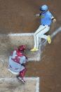 Cincinnati Reds catcher Austin Romine tags out Milwaukee Brewers' Victor Caratini at home during the sixth inning of a baseball game Saturday, Aug. 6, 2022, in Milwaukee. Caratini tried to score from second on a hit by Christian Yelich. (AP Photo/Morry Gash)