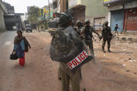 Indian paramilitary soldiers stand guard after Tuesday's violence in New Delhi, India, Wednesday, Feb. 26, 2020. At least 20 people were killed in three days of clashes in New Delhi, with the death toll expected to rise as hospitals were overflowed with dozens of injured people, authorities said Wednesday. The clashes between Hindu mobs and Muslims protesting a contentious new citizenship law that fast-tracks naturalization for foreign-born religious minorities of all major faiths in South Asia except Islam escalated Tuesday. (AP Photo/Manish Swarup)