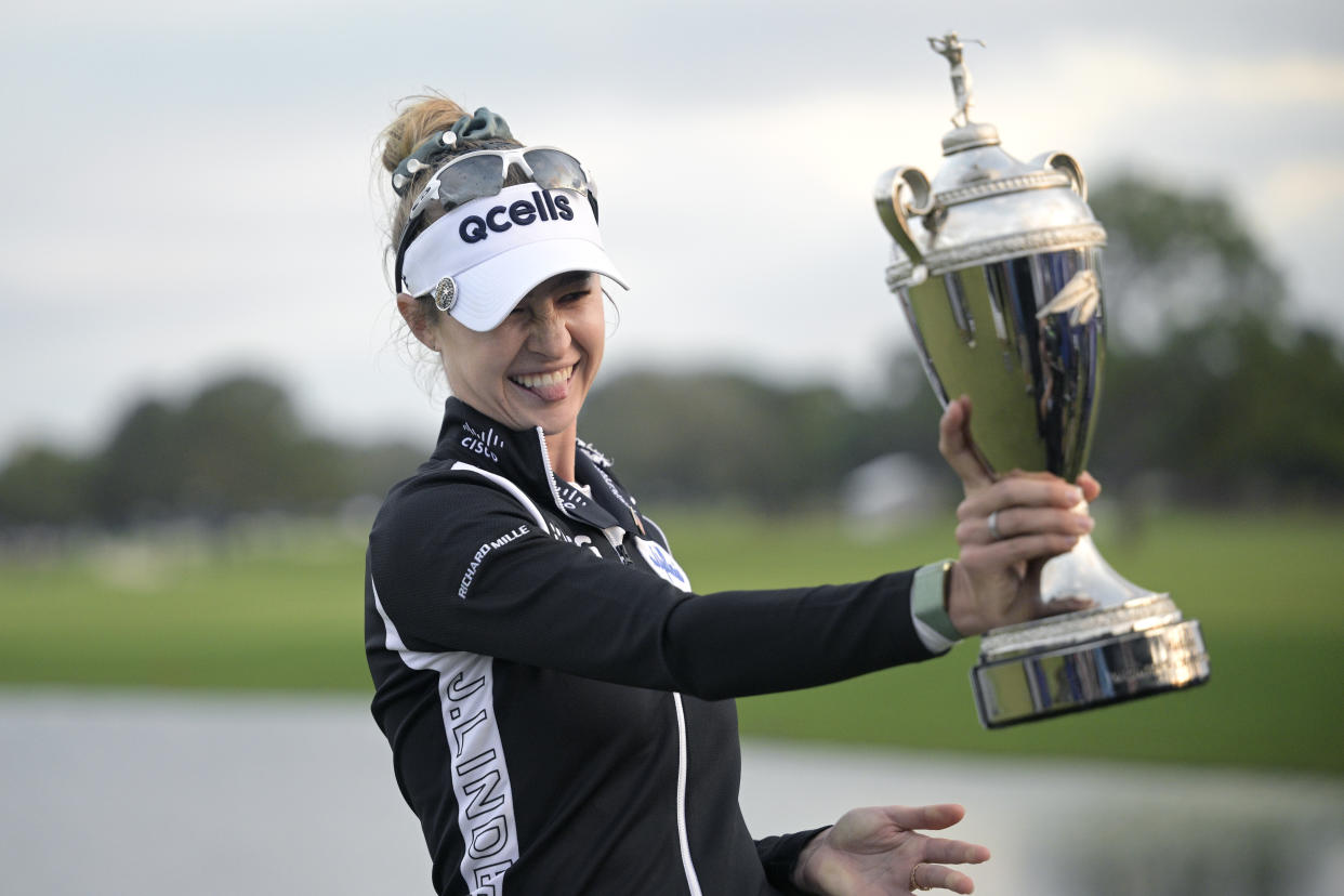 Nelly Korda shows the championship trophy after winning the LPGA Pelican Women's Championship golf tournament at Pelican Golf Club, Sunday, Nov. 13, 2022, in Belleair, Fla. (AP Photo/Phelan M. Ebenhack)