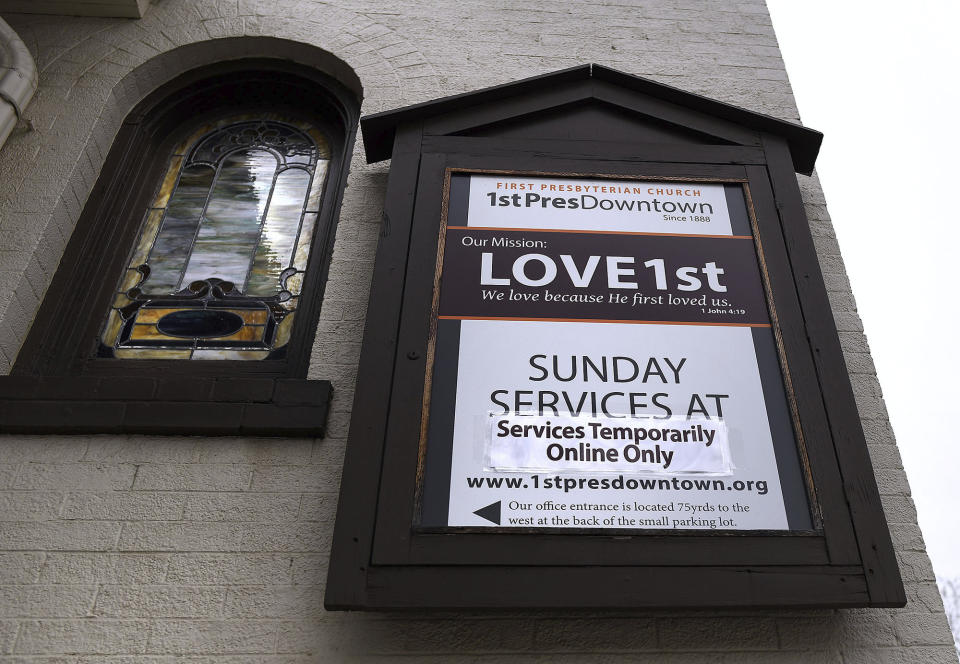 In this March 23, 2020 photo, a sign at the First Presbyterian Church in Coeur d'Alene, Idaho, gives notice that services will be held online only in efforts to help stop the spread of the new coronavirus. Far-right politicians across the U.S. are warning that state governments are using the coronavirus pandemic to trample on civil liberties. They are railing against efforts by state government leaders to close churches and gun stores and to prevent large public gatherings. (Kathy Plonka/The Spokesman-Review via AP)