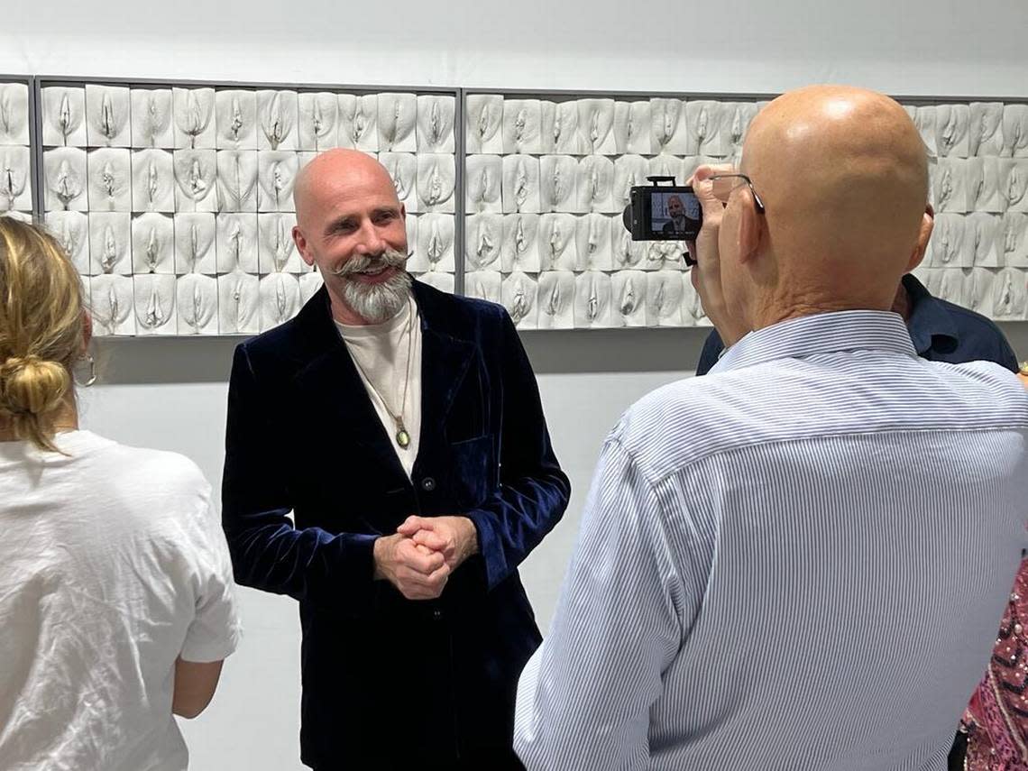 Artist Jamie McCartney talks to the press about his sculpture “The Great Wall of Vulva” at the Wilzig Erotic Art Museum in Miami Beach.