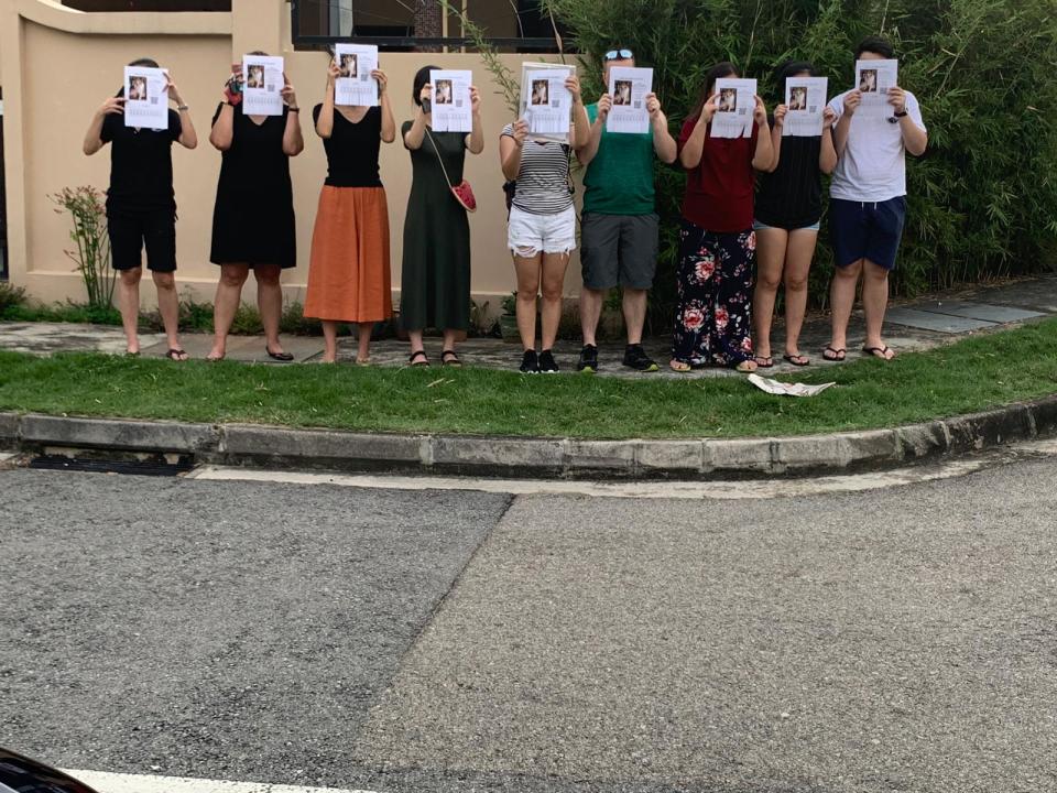 Nine persons carrying a Missing Dog notice bearing the picture of Prince, a seven-year-old Shetland sheepdog, who was boarded at Platinium Dogs Club and is currently missing. PHOTO: Derrick Tan