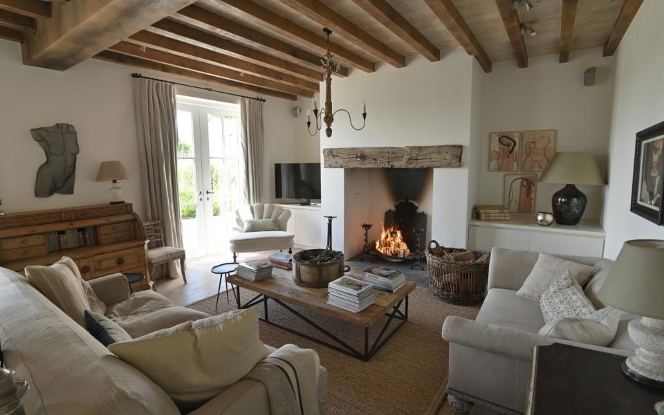 The living room with lit log fire in the Berman's home, Treverra Farm