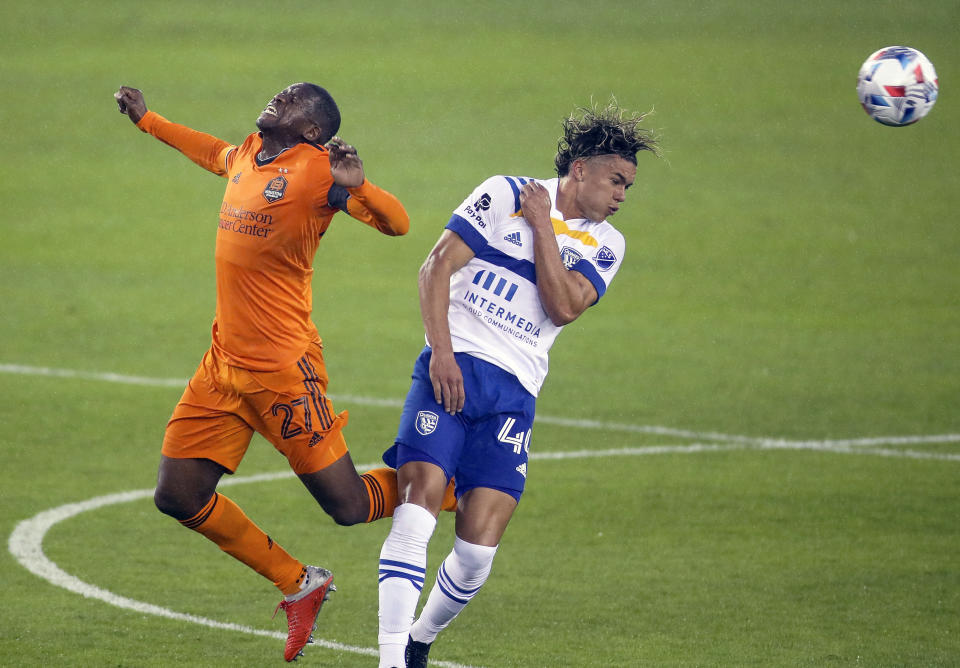 Houston Dynamo FC midfielder Boniek Garcia (27) and San Jose Earthquakes forward Cade Cowell (44) battle for the ball during the first half of an MLS soccer game at BBVA Stadium on Friday, April 16, 2021, in Houston. (Godofredo A. Vásquez/Houston Chronicle via AP)