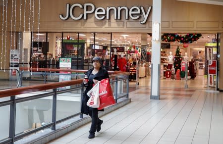 FILE PHOTO: FILE PHOTO: A shopper leaves the J.C. Penney department store in Illinois