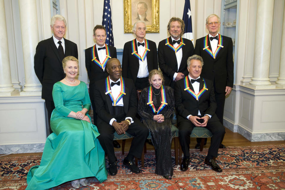 From left, former President Bill Clinton, Secretary of State Hillary Rodham Clinton join the 2012 Kennedy Center Honorees John Paul Jones, Buddy Guy, Jimmy Page, Natalia Makarova, Robert Plant, Dustin Hoffman, and David Letterman for a group photo after the State Department Dinner for the Kennedy Center Honors gala Saturday, Dec. 1, 2012 at the State Department in Washington. (AP Photo/Kevin Wolf)