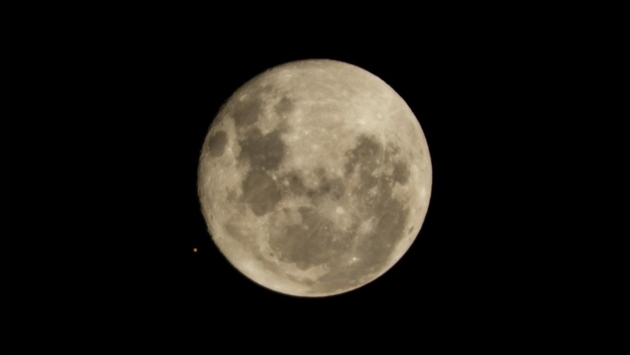  The moon and Mars (tiny orange dot) appear side by side in the sky before an occultation  