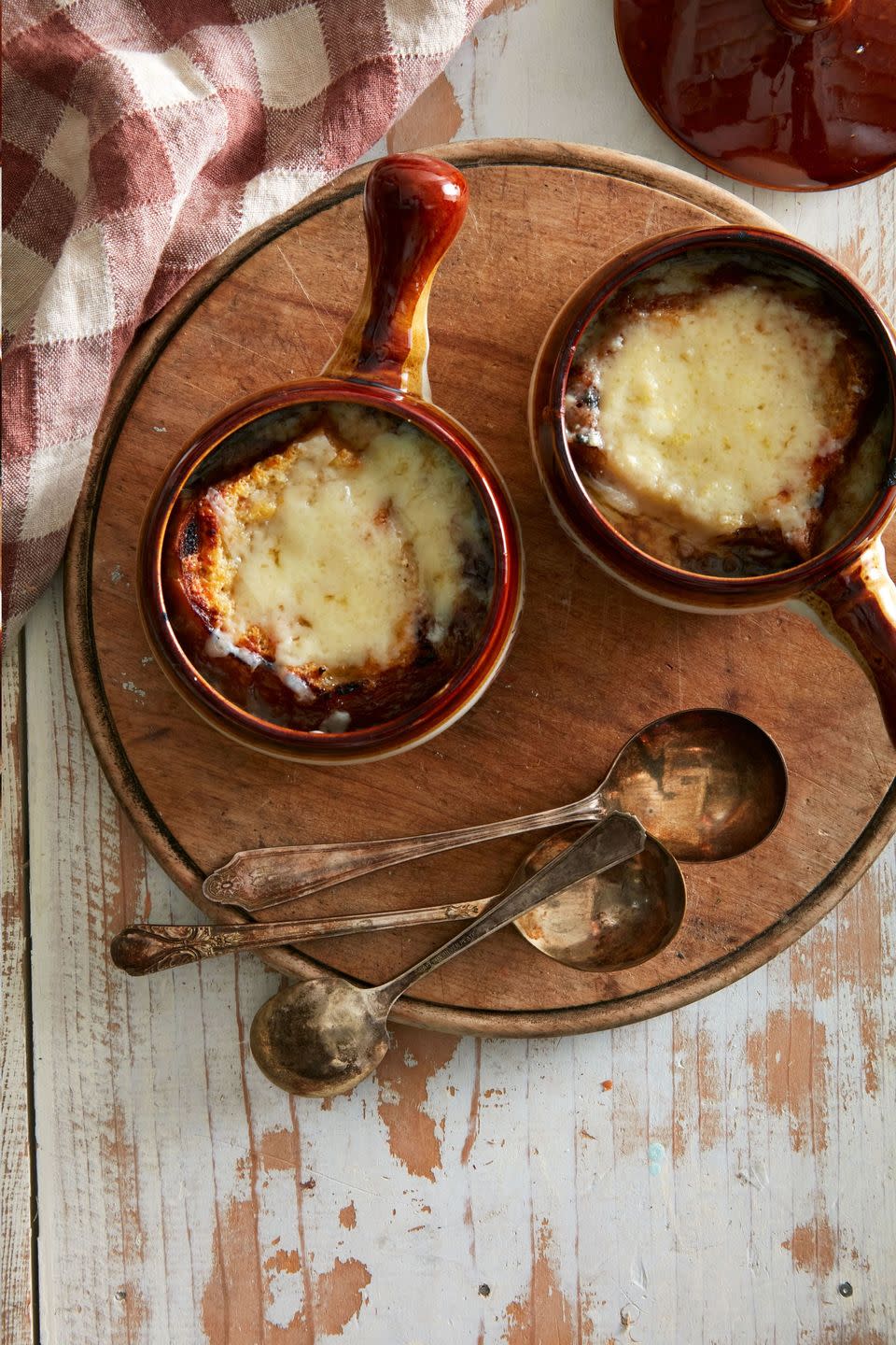 french onion soup in soup crocks with spoons