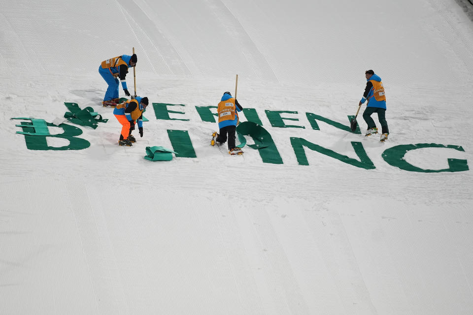 ZHANGJIAKOU, CHINA - DECEMBER 05:  Workers removed the signs after Women's normal hill individual finals during the 2021/2022 FIS Ski Jumping Continental Cup, a test event for the Beijing 2022 Winter Olympics at National Ski Jumping Centre at National Ski Jumping Centre on December 5, 2021 in Zhangjiakou, China.  (Photo by Lintao Zhang/Getty Images)