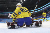 A shot by Japan gets past Sweden goalkeeper Emma Soderberg (30) for a score during a preliminary round women's hockey game at the 2022 Winter Olympics, Thursday, Feb. 3, 2022, in Beijing. (Jonathan Ernst/Pool Photo via AP)