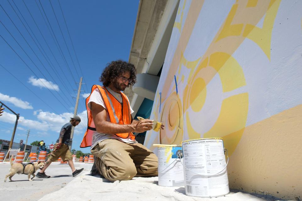 Jacksonville artist David Nackashi works on his latest mural project on the Murray Hill facing side of the Roosevelt Blvd. overpass over Edgewood Ave. Monday, April 29, 2024. The mural is part of the roundabout road project between the overpass and the start of the Murray Hill business district, and because of that, the Department of Transportation restricting the use of symbols, faces, signs or forced perspective could not be used in the artwork so Nackashi used geometry as the springboard for his inspiration. [Bob Self/Florida Times-Union]
