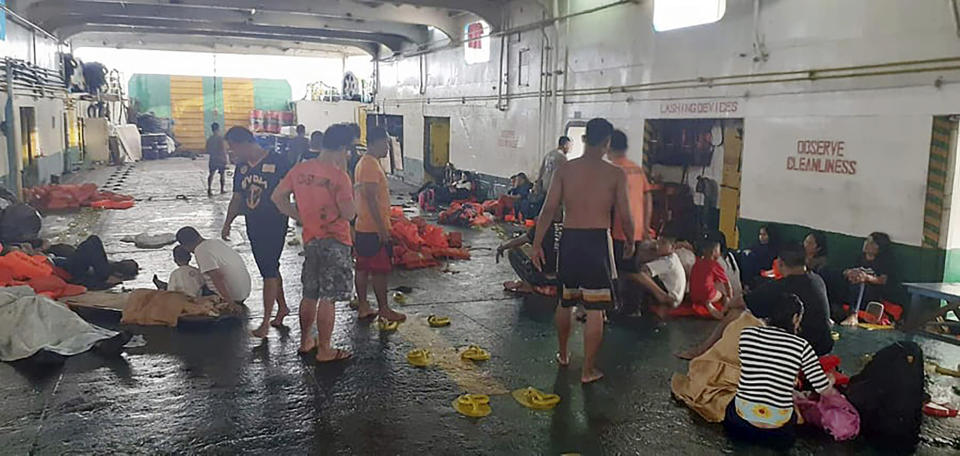 In this photo provided by Philippine Coast Guard in Manila, rescued passengers of the ill-fated M/V Lite Ferry 16, are attended to by the coast guard rescuers and crew of responding vessels, on a ferry which responded to the incident, following an overnight ferry fire Wednesday, Aug. 28, 2019, off Dapitan city in Zamboanga del Norte province in southern Philippines. (Philippine Coast Guard via AP)