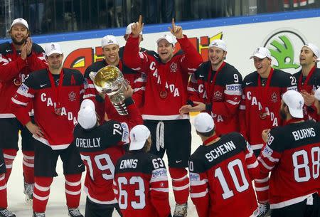 Canada's players celebrate with the trophy after defeating Russia in their Ice Hockey World Championship final game at the O2 arena in Prague, Czech Republic May 17, 2015. REUTERS/Laszlo Balogh