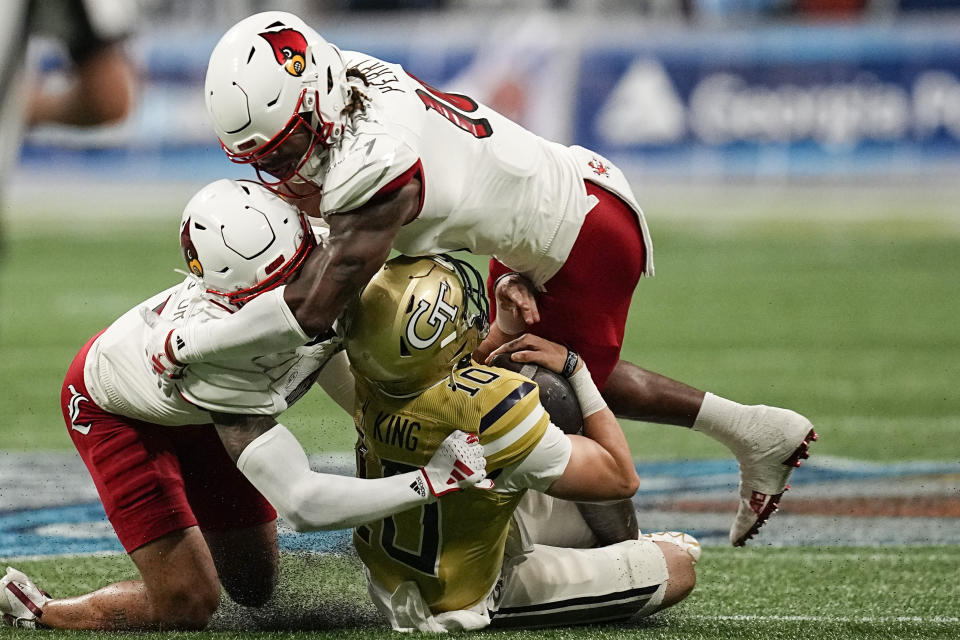 Georgia Tech quarterback Haynes King (10) is hiot by Louisville defensive back Benjamin Perry (10) during the first half of an NCAA college football game, Friday, Sept. 1, 2023, in Atlanta. (AP Photo/Mike Stewart)