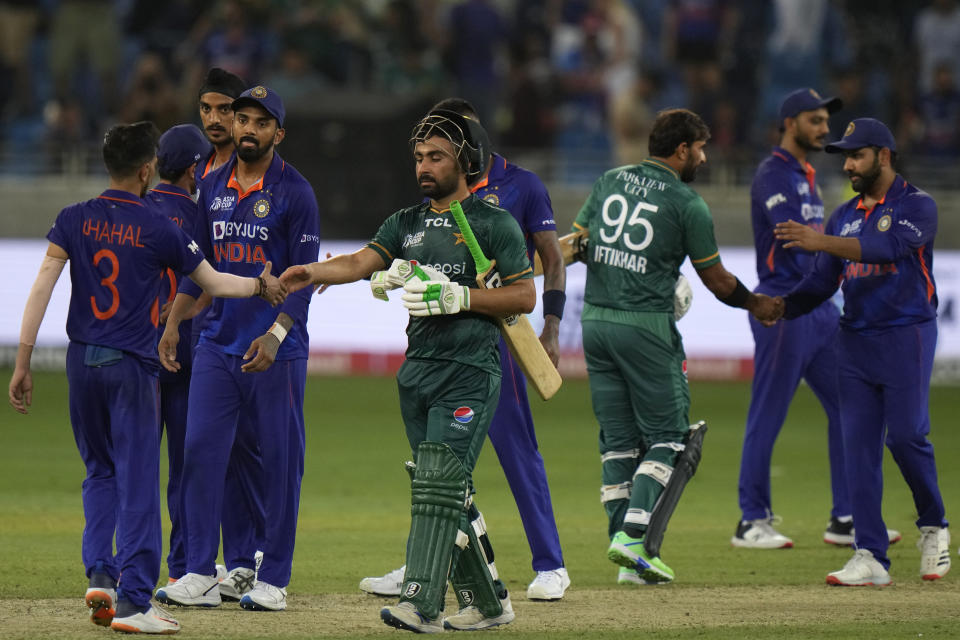 Pakistan batters Khushdil Shah, center, and Iftikhar Ahmed, third right, are greeted by Indian players after Pakistan won the T20 cricket match of Asia Cup against India, in Dubai, United Arab Emirates, Sunday, Sept. 4, 2022. (AP Photo/Anjum Naveed)