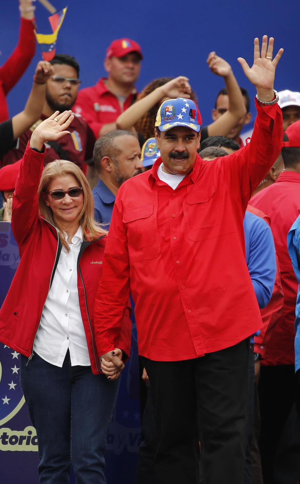 Venezuela's President Nicolas Maduro and first lady Cilia Flores acknowledge supporters at the end of a rally in Caracas, Venezuela, Saturday, Feb. 2, 2019. Maduro called the rally to celebrate the 20th anniversary of the late President Hugo Chavez's rise to power. (AP Photo/Ariana Cubillos)