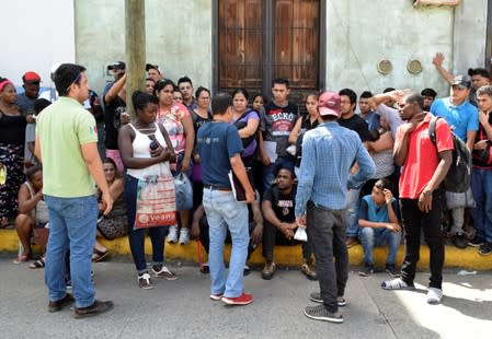 Migrants wait to hand in applications outside the Mexican Commission for Refugee Assistance (COMAR) in Tapachula