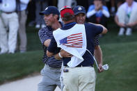 Dustin Johnson of the USA celebrates his birdie putt on the 17th green with Matt Kuchar and caddie Lance Bennett during day two of the Afternoon Four-Ball Matches for The 39th Ryder Cup at Medinah Country Club on September 29, 2012 in Medinah, Illinois. (Photo by Ross Kinnaird/Getty Images)