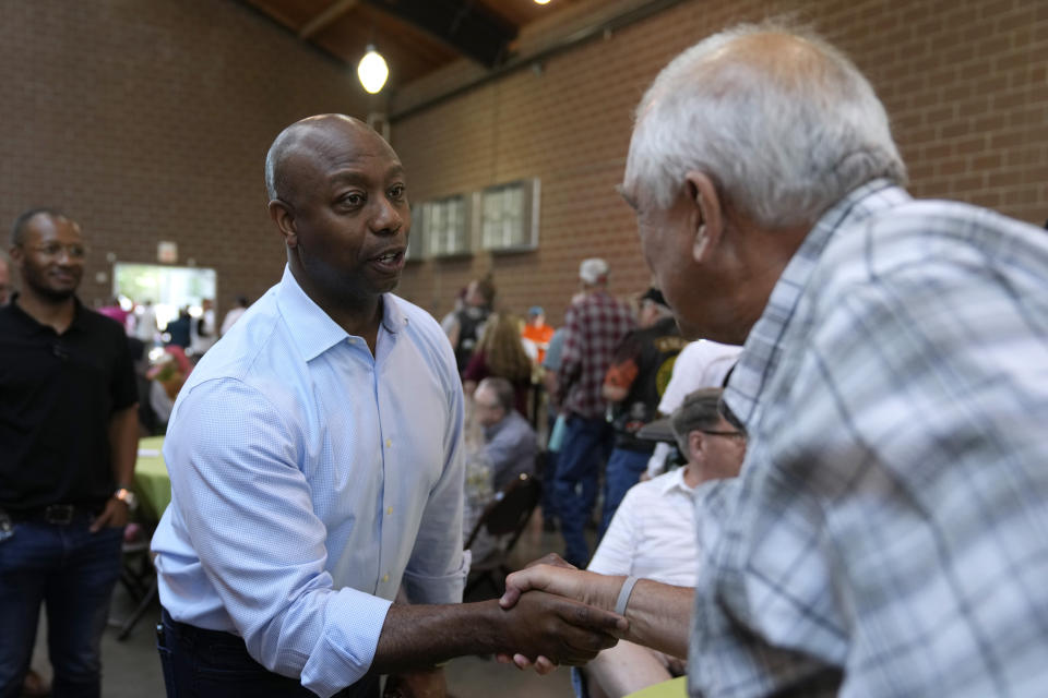 Republican presidential candidate South Carolina Sen. Tim Scott greets an audience member during U.S. Sen. Joni Ernst's Roast and Ride, Saturday, June 3, 2023, in Des Moines, Iowa. (AP Photo/Charlie Neibergall)