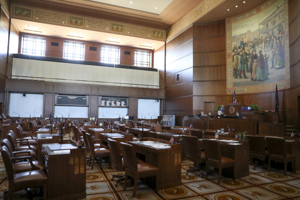 FILE - Empty chairs are shown in the Senate chambers prior to a legislative session at the Oregon State Capitol in Salem, Ore., May 11, 2023. The longest-ever walkout in the Oregon Legislature reached its fourth week on Wednesday, May, 31, 2023, as the enforceability of a ballot measure that would disqualify the boycotters from reelection in their next term appeared in doubt. (AP Photo/Amanda Loman, File)