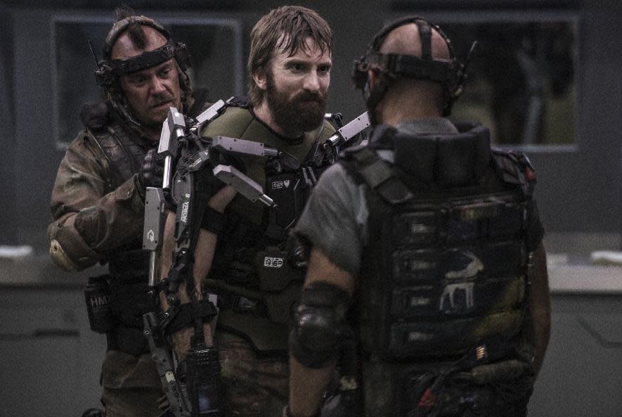 This film publicity image released by TriStar, Columbia Pictures-Sony shows Sharlto Copley, center, in a scene from "Elysium." (AP Photo/TriStar, Columbia Pictures - Sony, Kimberley French)