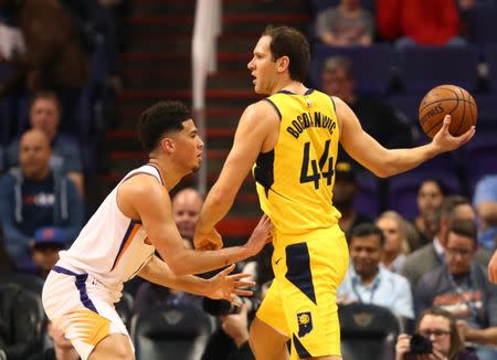 Nov 27, 2018; Phoenix, AZ, USA; Phoenix Suns guard Devin Booker (left) defends against Indiana Pacers forward Bojan Bogdanovic in the first quarter at Talking Stick Resort Arena. Mandatory Credit: Mark J. Rebilas-USA TODAY Sports