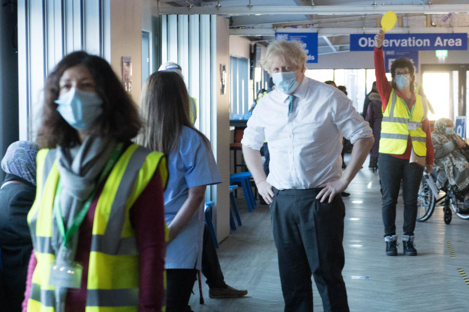 Prime Minister Boris Johnson meets staff and patients at Barnet FC's ground, The Hive, north London, which is being used as a coronavirus vaccination centre. Picture date: Monday January 25, 2021.