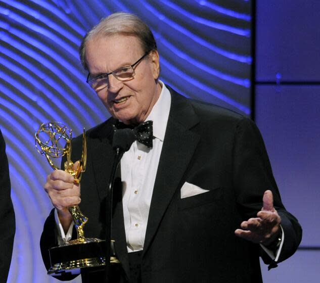 FILE - Charles Osgood accepts the award for outstanding morning program for "CBS Sunday Morning" at the 40th Annual Daytime Emmy Awards on June 16, 2013, in Beverly Hills, Calif. Osgood, who anchored the popular news magazine's for more than two decades, was host of the long-running radio program "The Osgood File" and was referred to as CBS News' poet-in-residence, has died. He was 91. (Photo by Chris Pizzello/Invision/AP, File)