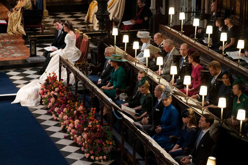 Jack Brooksbank and Princess Eugenie of York sit near the royal family, (back L-R) Queen Elizabeth II, Prince Philip, Duke of Edinburgh, Prince Charles, Prince of Wales, Prince William, Duke of Cambridge, Catherine, Duchess of Cambridge, Prince Harry, Duke of Sussex, Meghan, Duchess of Sussex and Princess Anne, Princess Royal and (front L-R) Sarah Ferguson Princess Beatrice of York, Peter Phillips, Autumn Phillips, Mike Tindall, Zara Tindall Lady Louise Windsor and Crown Prince Pavlos of Greece during their wedding ceremony at St. George's Chapel on October 12, 2018 in Windsor, England.