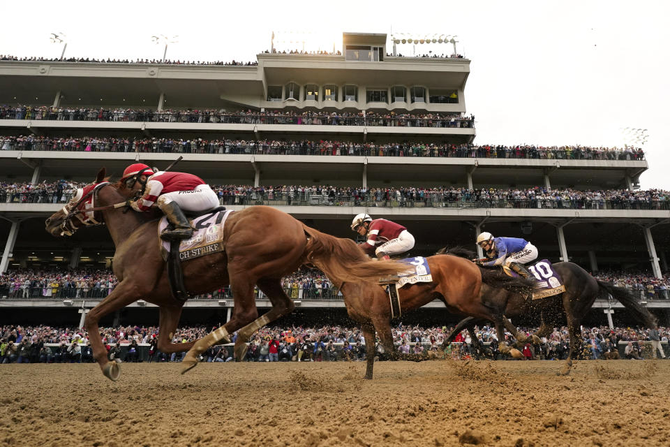 Rich Strike (21), with Sonny Leon aboard, leads Epicenter (3), with Joel Rosario aboard, and Zandon (10), with Flavien Prat aboard, as Rich Strike wins the 148th running of the Kentucky Derby horse race at Churchill Downs Saturday, May 7, 2022, in Louisville, Ky. (AP Photo/Charlie Riedel)