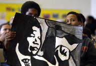 Basboos Zein (L) and Jalo Ismael (R) attend a ceremony at Nelson Mandela Park Public School in Toronto, December 6, 2013. Students, staff and school board officials gathered at the school to pay tribute to Mandela with songs and tributes. Mandela visited the school, which was previously known as Park Public, on November 17, 2001, when it was renamed in his honour. South African anti-apartheid hero Mandela died at the age of 95 on Thursday. REUTERS/Aaron Harris (CANADA - Tags: EDUCATION POLITICS OBITUARY)